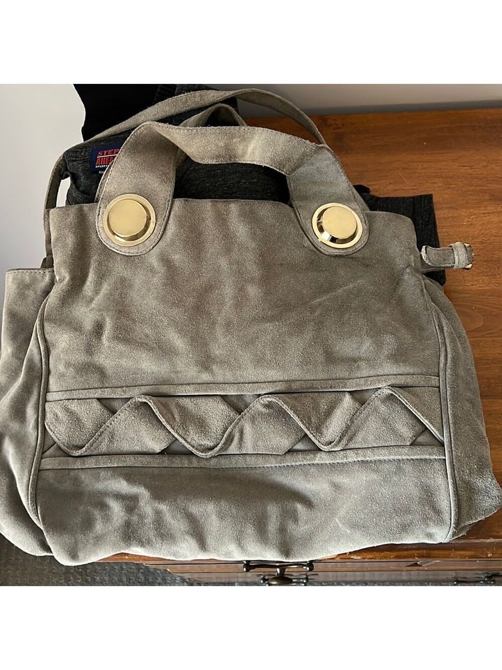 Gustto suede handbag with gold accents. Gray